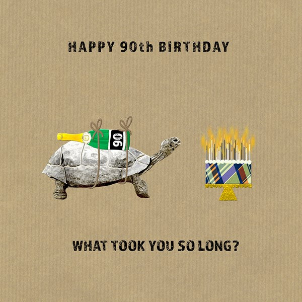 A tortoise carrying a bottle of champagne on its shell with the number 90 next to a birthday cake with lit candles.s