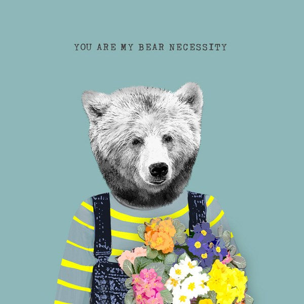 Bear wearing a striped top and dungarees, holding a bunch of flowers.