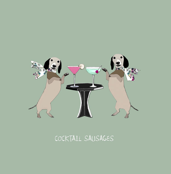 Two dachshunds standing up at a bar table. Both with a cocktail.